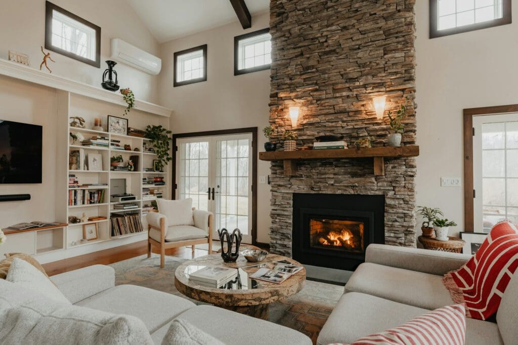 A bright and elegant living room, featuring a beautiful brick fireplace. This inviting space shows the warmth and charm that a lease to own home can offer, providing a stylish and comfortable living environment for future homeowners.