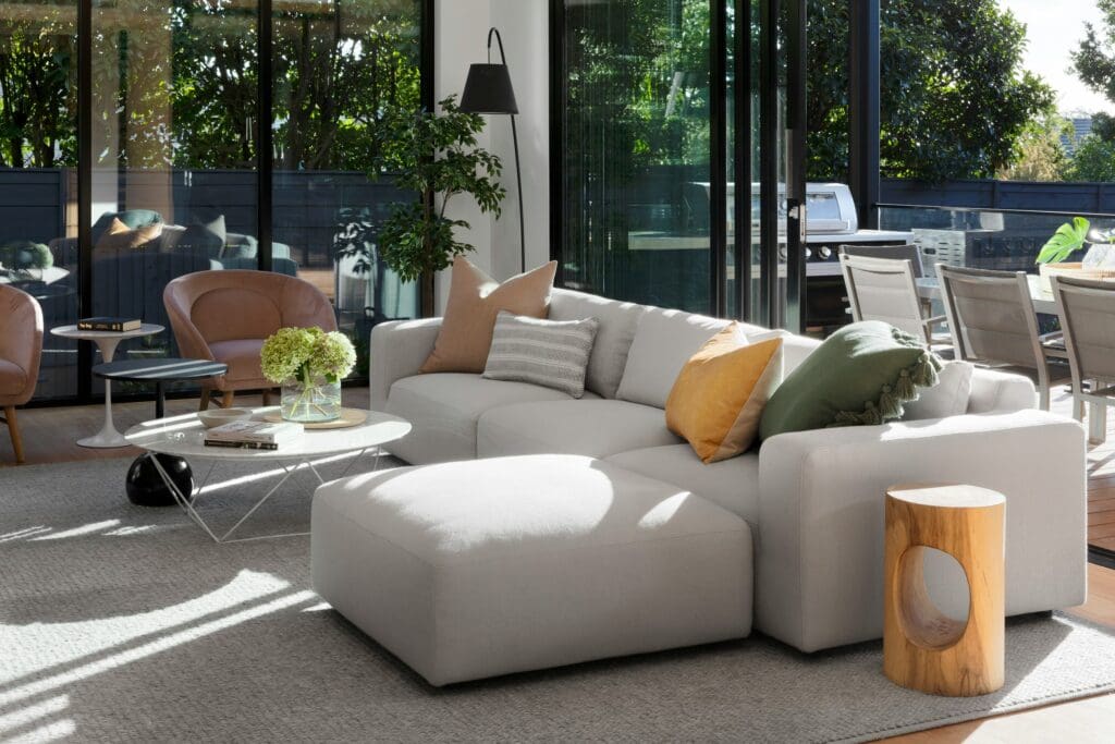 View of spacious living room with ceiling to floor window overlooking outdoor eating area in Lease to Own home in NC
