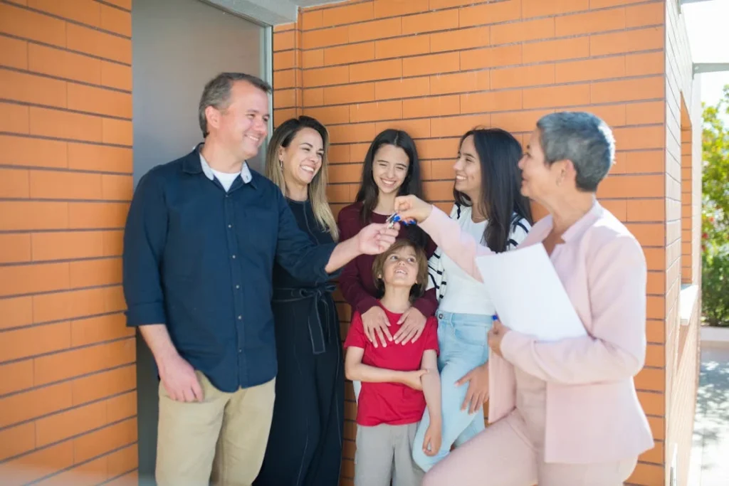 Happy multigenerational family outside their home, symbolizing financial stability and long-term success through creative options like Lease-to-Own Raleigh Homes.