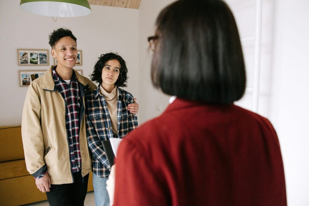 Couple touring a home with a real estate agent, representing flexible paths to homeownership like Lease-to-Own Raleigh Homes in a shifting 2025 market.