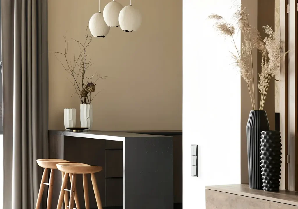 Modern kitchen interior with minimalist neutral decor, wooden stools, and stylish vases in a lease to own Greensboro home--building eqity without a mortgage.